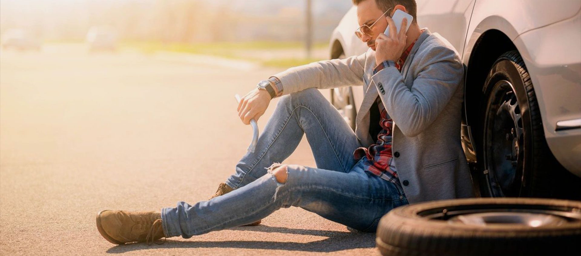 Man talking to over phone to road assistant